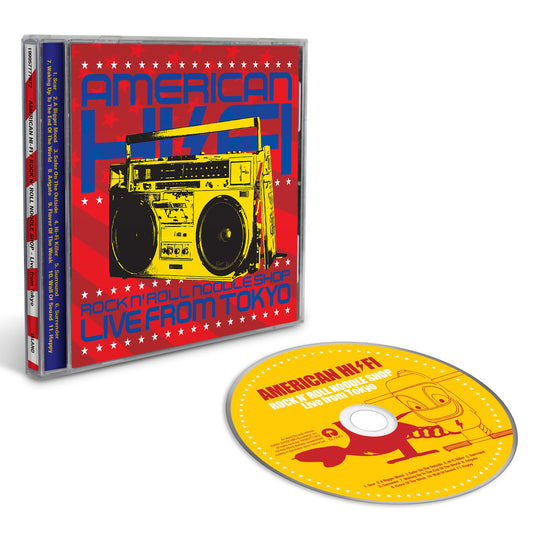 A CD case and matching CD disc for the album 'American Hype: Live from Tokyo' are shown on a clean white background. The cover art features a red background with white stars, blue text, and a yellow boombox illustration, while the disc is predominantly yellow with red and blue graphics.